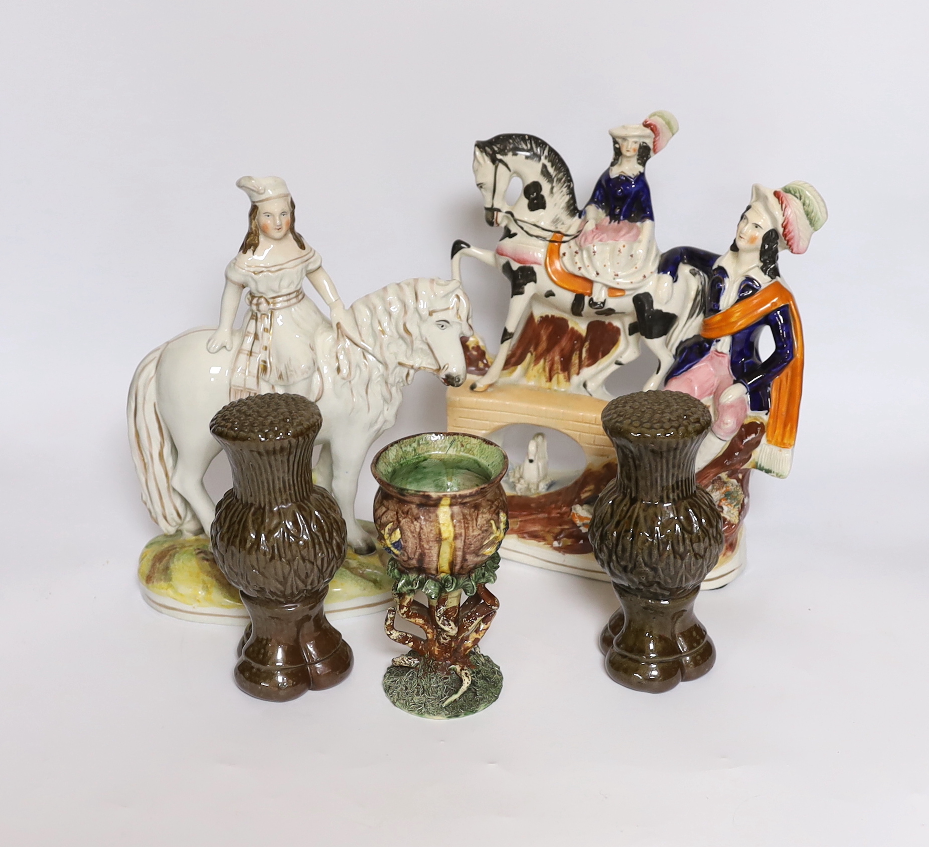 A rare Staffordshire horse group, a Princess Royal and pony group, a Palissy ware vase and a pair of stoneware thistle curtain finials, tallest 25cm